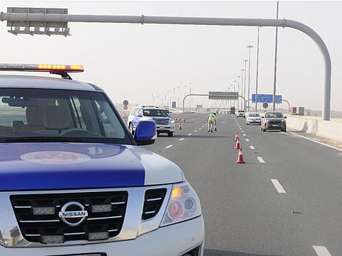 Abu Dhabi police blocking a section of a road.
