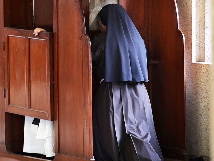 A nun partakes in the sacrament of confession