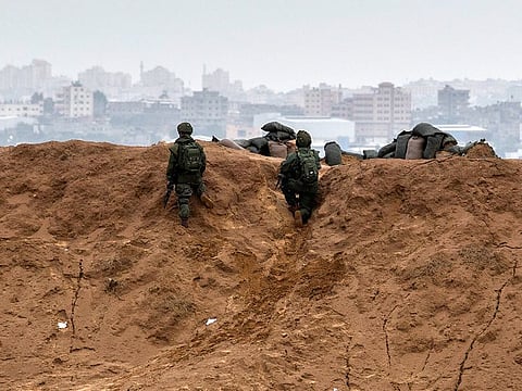 Israeli soldiers man a position on the Israel Gaza border, overlooking Gaza, during a protest.