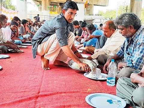 Syed Osman Azhar Maqsusi serves a hot meal of boiled rice and lentils in Hyderabad. 