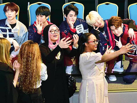 Fans share a moment with Lucente members.