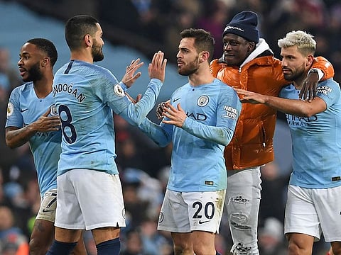 Manchester City players celebrate after Sergio Aguero scored the first goal against Liverpool in the premier league Thursday.