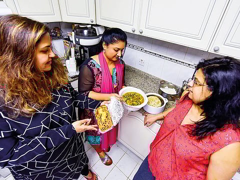 From left: Maneka Wadhwani, Lata Bhadra and Divya Punwaney, all residents of an apartment complex on Shaikh Zayed Road, pack freshly cooked meals for workers in their building.