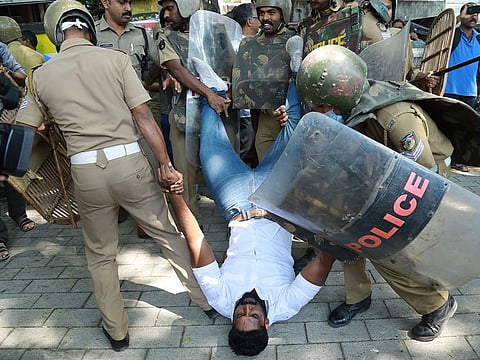 Police detain an activist amid demonstrations after women entered the Sabarimala temple, in Kochi in southern Kerala state, on January 4, 2019.  