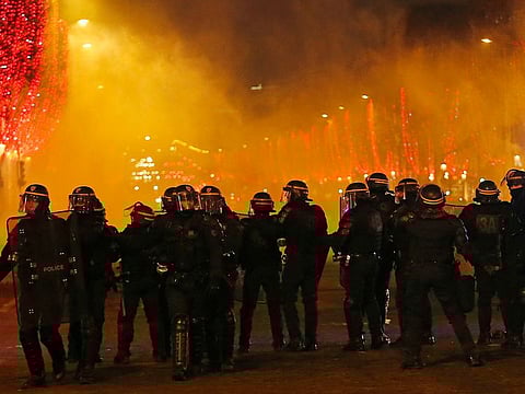 Riot police officers take position at the Champs Elysees avenue during a yellow vest protest