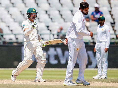 South African batsman Dean Elgar (L) celebrates after South Africa defeated Pakistan on the fourth day of the second Test cricket match between South Africa and Pakistan at Newlands Cricket Stadium in Cape Town on January 6, 2019.  