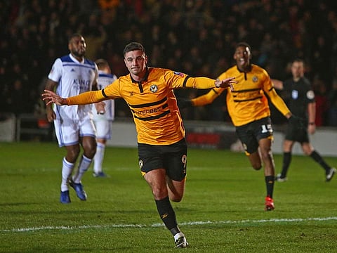 Newport County's Irish striker Padraig Amond (C) celebrates after scoring their second goal.