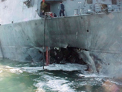 the port side of the guided missile destroyer USS Cole  damaged after a suspected terrorist bomb exploded during a refueling operation in the port of Aden in Yemen.   