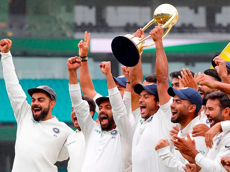 India's captain Virat Kohli (L) celebrates with teammates