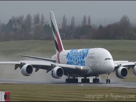 Pilots finally manage to land world's biggest plane after being buffeted by strong winds.
