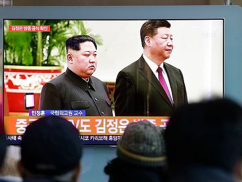 People watch a TV screen showing file footage of North Korean leader Kim Jong Un and Chinese President Xi Jinping, right, during a news program at the Seoul Railway Station in Seoul, South Korea, Tuesday, Jan. 8, 2019. 