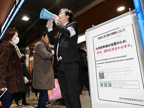 A staff of West Japan Railway Company updates the operation information for stranded passengers as an earthquake stopped and delayed some train services at JR Hakata station in Fukuoka, western Japan, Thursday, Jan. 3, 2019. 