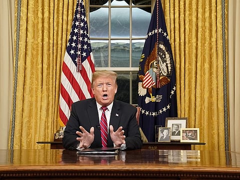 US President Donald Trump delivers a televised address to the nation on funding for a border wall from the Oval Office of the White House in Washington DC on January 8, 2019.