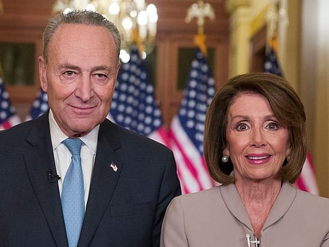 Senate Minority Leader Chuck Schumer of N.Y., and House Speaker Nancy Pelosi of Calif., pose for photographers after speaking on Capitol Hill in response President Donald Trump's address, Tuesday, Jan. 8, 2019, in Washington. 