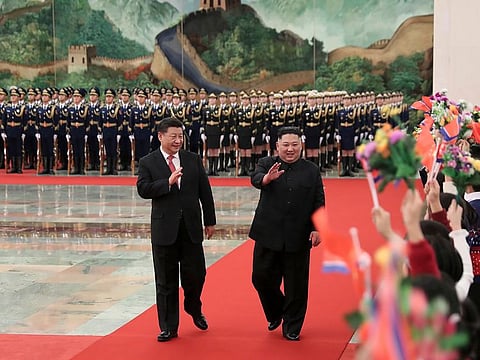 North Korean leader Kim Jong Un, right, is cheered by the children during a welcome ceremony held by Chinese President Xi Jinping, at the Great Hall of the People in Beijing.