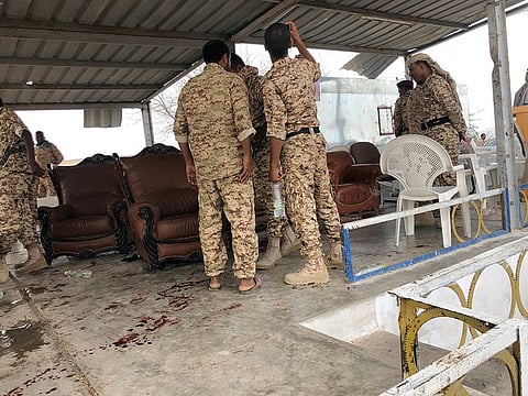 Soldiers inspect the scene of Al Houthi drone attack at Yemeni government military parade in AL Anad air base