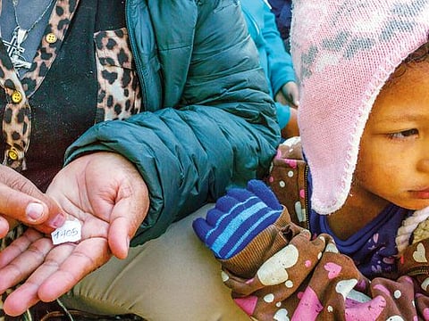 Elda Montes, from Honduras, shows her asylum number request at a shelter for migrants, in Tijuana, Mexico, Nov. 27, 2018. 