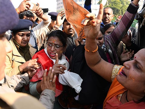 Police officers detain hardline Hindu protesters as they shout slogans outside the Supreme Court in New Delhi, after the hearing in the Babri Masjid case was further deferred.