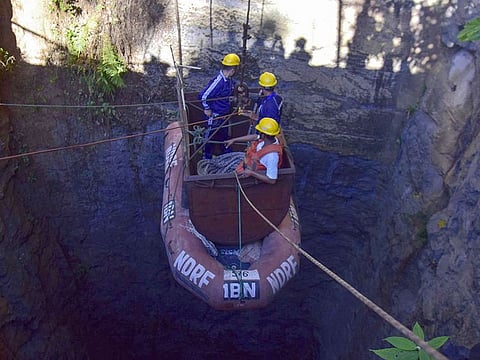  In this file photo taken on December 30, 2018 Indian Navy divers are lowered into a mine with a pulley during rescue operations to help 15 miners trapped by flooding in an illegal coal mine in Ksan village in Meghalaya's East Jaintia Hills district.