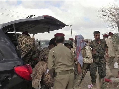 An image grab taken from a video obtained by AFPTV shows Yemeni soldiers reacting after a drone exploded above Yemen's al-Anad airbase in the government-held southern province of Lahj.