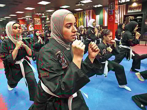 Kuwaiti girls and women practise Kajukenbo, a hybrid martial art form, in a club in Kuwait City.