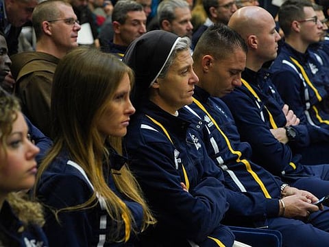 Sister Marie Theo, third from left, sits among other athletes of the Athletica Vaticana Vatican sports team, as they attend a press conference, at the Vatican