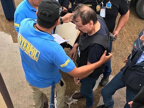A picture handout by the Polizia di Stato on January 13, 2019 shows former far-left Italian militant Cesare Battisti (R) escorted by Interpol police officers.