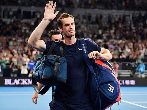 Andy Murray waves to supporters after his defeat against Roberto Bautista Agut during their men's singles match on day one of the Australian Open tennis tournament in Melbourne on January 14, 2019. 
