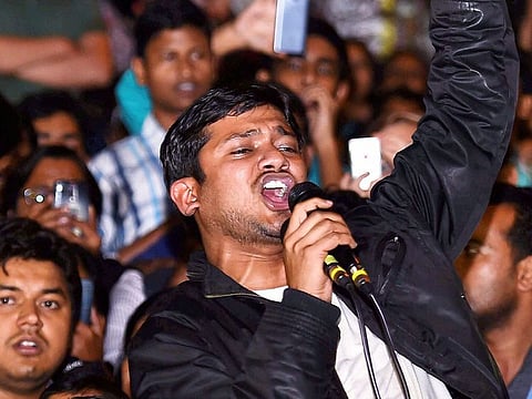In this file photo dated March 03, 2016, Jawaharlal Nehru University Students' Union (JNUSU) president Kanhaiya Kumar raises slogans after reaching at the JNU campus upon his release on bail, in New Delhi.