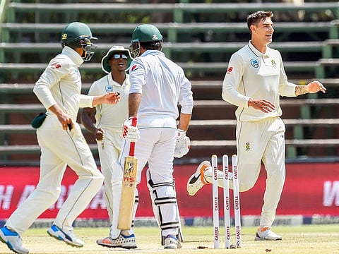 Pakistan's batsman Sarfraz Ahmed, second right, bowled out for 0 by South Africa's bowler Duanne Olivier, right, on day four of the third cricket test match between South Africa and Pakistan at Wanderers Stadium in Johannesburg, South Africa, Monday, January 14, 2019. 