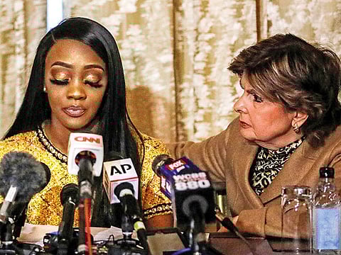 Faith Rodgers reads a statement to reporters with attorney Gloria Allred during a news conference.