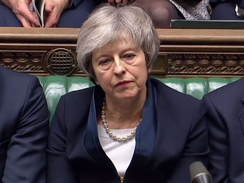 Britain's Prime Minister Theresa May reacting as Labour Party leader Jeremy Corbyn informs the MPs that he has tabled a vote of no confidence.