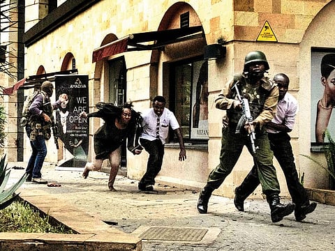 People flee after the bomb blast at DusitD2 hotel in Nairobi, Kenya, on Tuesday.  A huge blast followed by a gun battle rocked the upmarket hotel and office complex.