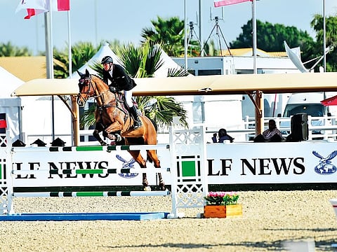 Jockey Jorg Naeve, riding Be Aperle Va, clears a fence during the Emirates Airlines Welcome Stakes at the Dubai Show Jumping Championship on Thursday.