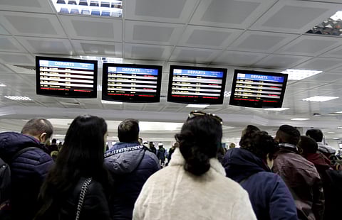 Passengers look at information boards at the Tunis airport during a nationwide strike in Tunis, on January 17, 2019.