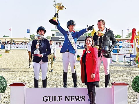 Winner Alice Debany flanked by Tina Lund (left) and Jorg Naeve pose on the podium at the award ceremony of the Gulf News Cup at the Dubai Show Jumping Championship yesterday. Safiya Jomaa, Advertising Sales Manager, Gulf News presented the award.