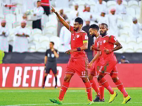 Oman’s midfielder Ahmad Al Mahaijri (left) gestures after scoring during the Group F match against Turkmenistan at the Mohammad Bin Zayed Stadium in Abu Dhabi on Thursday.