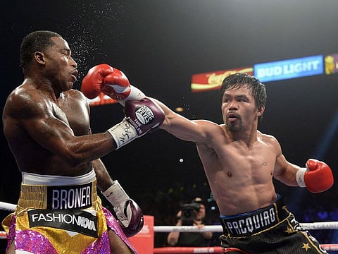 Manny Pacquiao (black trunks) and Adrien Broner (purple/gold trunks) box during a WBA welterweight world title boxing match at MGM Grand Garden Arena. Pacquiao won via unanimous decision.