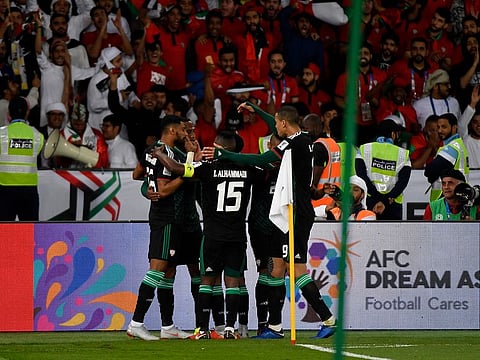 UAE's players celebrate their third goal.