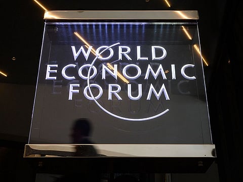 A man walks past a sign of the World Economic Forum (WEF) in Davos, eastern Switzerland  