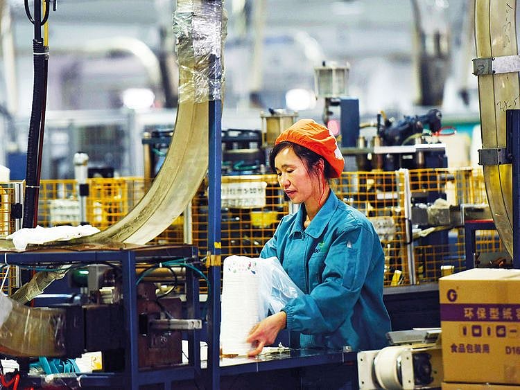 A woman works on a production line