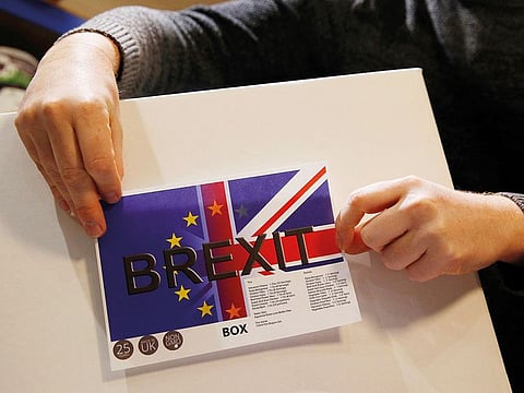 James Blake from emergency food storage.co.uk sticks a label on the company's 'Brexit Box' which contains dehydrated food, water purifying kit and fire starting gel at their warehouse in Leeds, Britain 