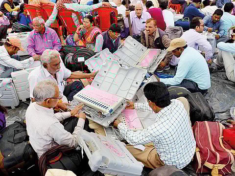 Polling officers checking Electronic Voting Machines before leaving for poll duty from a distribution centre, on the eve of last phase of 2017 UP Assembly elections in Mirzapur in this file photo.
