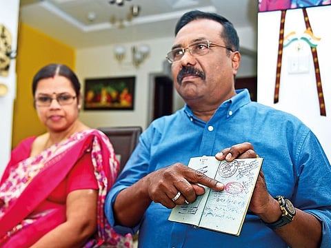 T. V. Sugathan shows the date of his arrival in the UAE (November 8, 1976) during an interview with Gulf News while his wife Rajeshwari looks on. The couple wil be leaving the UAE shortly.