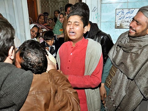 Relatives of a family killed by counter-terrorism officers, mourn following the news of family's death, outside their home in Lahore, Pakistan, last week. 