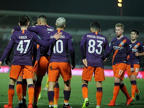 Manchester City's Sergio Aguero, 10, celebrates scoring his side's goal with teammates.
