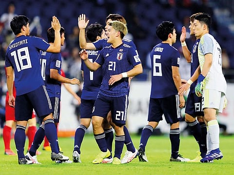 Japan's Ritsu Doan and team mates celebrate at the end of the match.  
