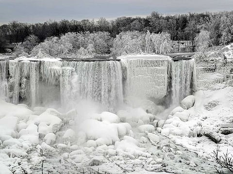 Water flows around ice, formed on the American Falls in Niagara Falls, viewed from the Canadian side, Ontario. 