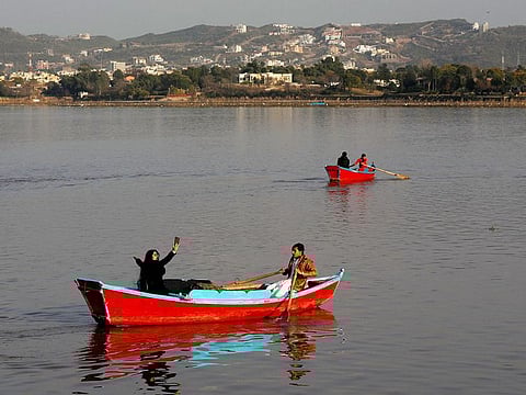 A woman takes a selfie while riding on a boat at the Rawal Lake in Islamabad, Pakistan. Image for illustrative purposes only. 