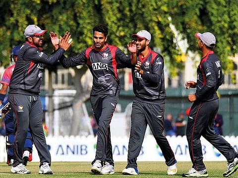 UAE pacer Amir Hayat who bagged the man of the match award against Nepal,  being congratulated by teammates on taking a wicket.